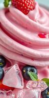 Delicious pink whipped dessert topped with fresh blueberries and mint leaves in a close-up view showcasing its creamy texture photo