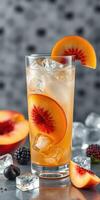 Refreshing peach drink with ice and berries in a stylish glass on a textured background photo