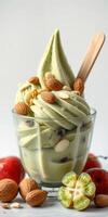 Delightful green tea soft serve topped with nuts and seasonal fruits in a glass cup at a dessert shop photo