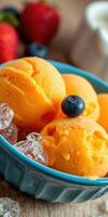 Enjoying delicious mango sorbet served with ice and fresh berries in a vibrant bowl photo
