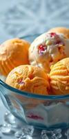 A refreshing bowl of colorful ice cream featuring orange and cream flavors with cherries on a sunny afternoon photo