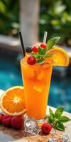 Refreshing tropical cocktail with fresh fruit garnishes by the poolside on a sunny day photo