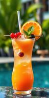 Vibrant tropical cocktail garnished with fresh fruit near a swimming pool in sunny weather photo