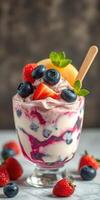 Delightful berry parfait layered with whipped cream and fresh fruit served in a glass cup photo