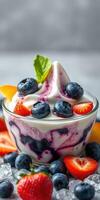 Delicious dessert bowl with berries and fruit served on a bright table photo