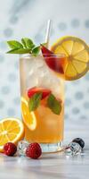 Refreshing citrus drink with ice, mint, and berries on a white table background photo