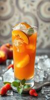 Refreshing peach iced tea with mint and strawberry garnishes served on a marble countertop photo