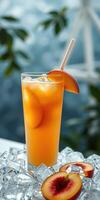 Refreshing peach iced drink garnished with fresh peach slices and served over ice cubes photo