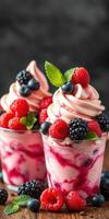 Delicious dessert with swirls of pink and cream topped with fresh berries and mint leaves photo