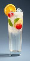 Refreshing summer drink with ice, mint, lemon, and cherry served in a tall glass photo