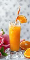 Refreshing citrus drink with ice and fruit slices on a table surrounded by flowers in a bright setting photo