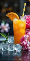 Refreshing orange cocktail served with ice and garnished with a flower in a vibrant setting photo