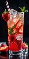 Refreshing strawberry drink garnished with fresh mint and ice cubes on a dark background photo