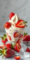 Delicious dessert featuring creamy whipped topping and fresh strawberries in a glass surrounded by ice cubes photo