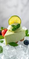 Refreshing green dessert slice garnished with lemon, mint, and berries on ice photo