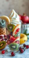 Delicious fruit parfait with vibrant layers of fresh strawberries, kiwis, and a swirl of creamy topping photo