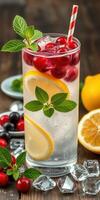 Refreshing beverage with mint, lemon slices, and red berries displayed on a wooden table in a cozy setting photo