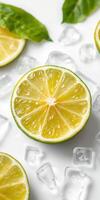 Freshly sliced yellow lime surrounded by ice cubes on a white surface photo