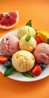Colorful ice cream scoops served with fresh fruit on a bright orange background photo