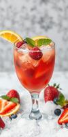 Refreshing summer cocktail with berries and citrus served over ice photo