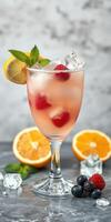 Refreshing fruit cocktail with mint and citrus garnishes served in elegant glass photo