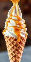 Creamy vanilla ice cream with caramel drizzle served in a crispy cone photo