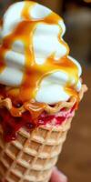 Delicious ice cream cone topped with whipped cream and drizzled caramel at a dessert shop on a sunny day photo