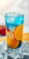 Refreshing blue cocktail with ice and citrus slices served in a tall glass photo