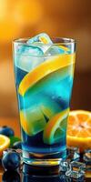 Refreshing blue citrus drink with ice and fruit garnishes during a sunny afternoon photo