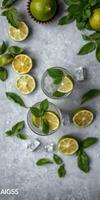 Refreshing mint lemonade with lime garnishes arranged on a textured gray surface photo