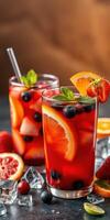 Refreshing summer drinks with colorful fruits and ice on a wooden table photo