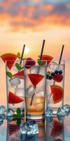 Refreshing summer cocktails with fruit garnishes against a vibrant sunset backdrop photo