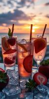 Refreshing summer cocktails with strawberries at sunset on a tropical beach photo