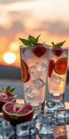Refreshing cocktails with ice and fruits at sunset over a scenic landscape photo