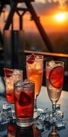 Colorful cocktails with fresh fruits served on a table during a sunset at a rooftop bar photo