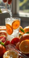 Refreshing citrus drink prepared with vibrant oranges and sparkling water in a bright kitchen setting photo