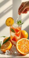 Refreshing citrus drink with fresh fruit and mint in bright natural light photo