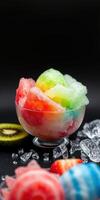 Colorful shaved ice dessert served in a bowl with fresh fruit and ice cubes on a dark background photo