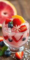 Colorful fruit cocktail with berries and citrus garnished on crushed ice photo