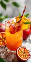 Refreshing fruit cocktail with vibrant colors and garnishes served in a clear glass on a summer day photo