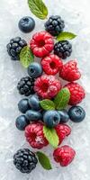 Fresh berries arranged on ice with mint leaves for a vibrant and healthy summer treat photo