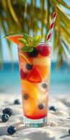 Refreshing fruit cocktail served on a sunny beach with palm trees in the background photo