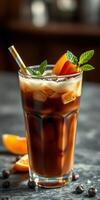 Refreshing iced coffee prepared with fresh mint and orange slices on a rustic table setting photo