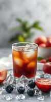 Refreshing cocktail served over ice with fresh fruit accents in a well-lit setting photo