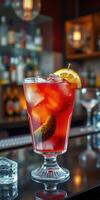 Refreshing cocktail garnished with orange slice served at a bar in the evening photo