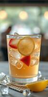 Refreshing iced beverage served with lemon and strawberries on a warm day photo