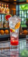 Refreshing fruit cocktail served with ice, garnished with watermelon and orange in a vibrant bar setting photo