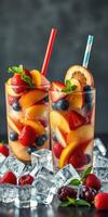 Refreshing fruit cocktails with strawberries, blueberries, and peaches served over ice on a dark background photo