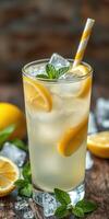 Refreshing lemon drink garnished with mint leaves and ice on a rustic wooden table photo