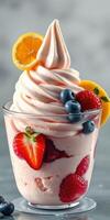 Delicious dessert featuring swirled strawberry soft serve topped with fresh fruit on a gray background photo